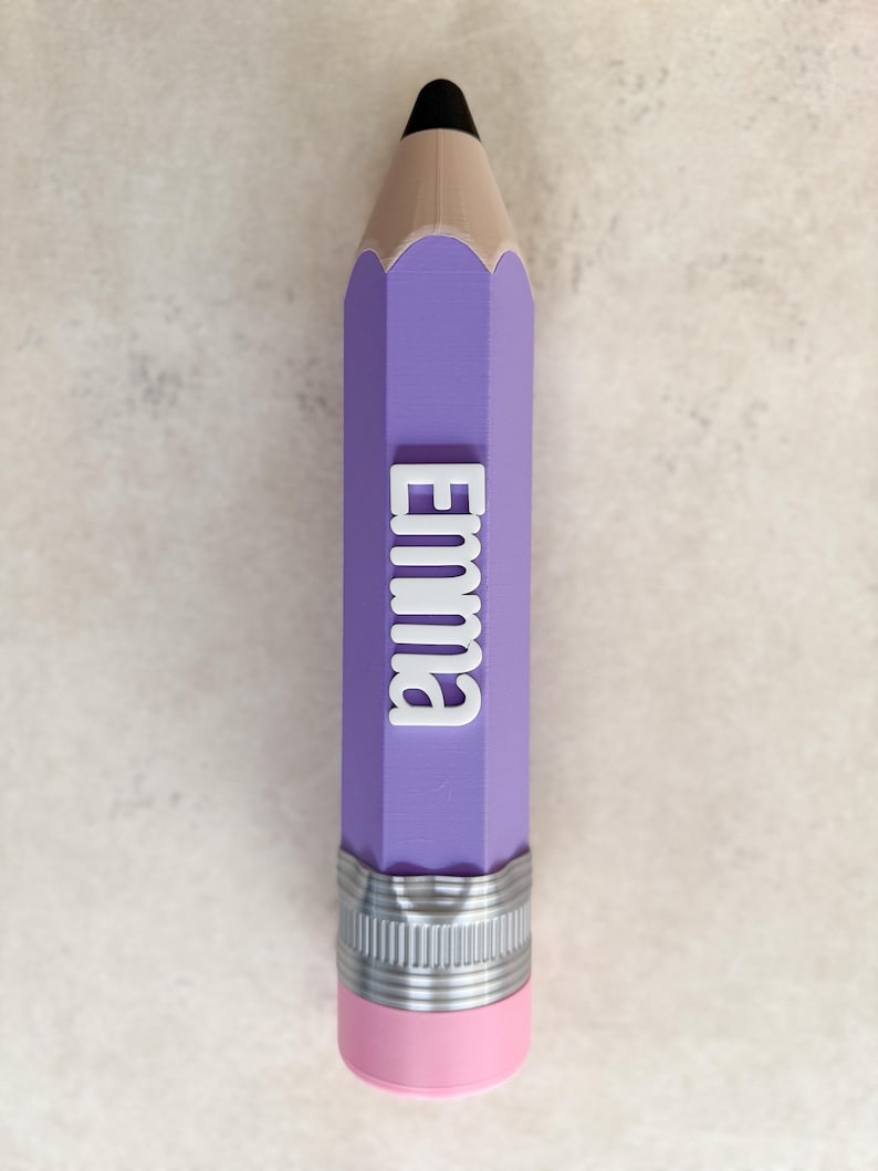 May include: A purple pencil-shaped object featuring a black tip, a tan wooden-coloured section, and a silver-coloured metal ferrule with a pink eraser at the base. The name Emma is displayed in raised white lettering along the purple body.