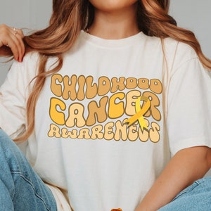 We Wear Gold For Childhood Cancer Awareness Shirt, Gold Cancer Ribbon Tshirt, Pediatric Oncology Nurse Tee, Kids Cancer Support Gift T-shirt
