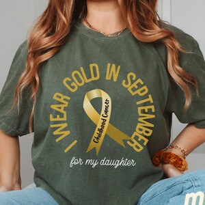 Personalized We Wear Gold For Childhood Cancer Awareness Shirt, Gold Cancer Ribbon Tshirt, Custom Kids Cancer Survivor Support Gift T-shirt