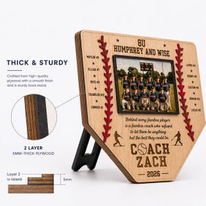 May include: A wooden baseball-shaped photo frame with a team photo. The frame has a natural wood finish, red stitching, and player names. Text includes "Coach Zach - 2026" and team details. The frame is 5mm thick.
