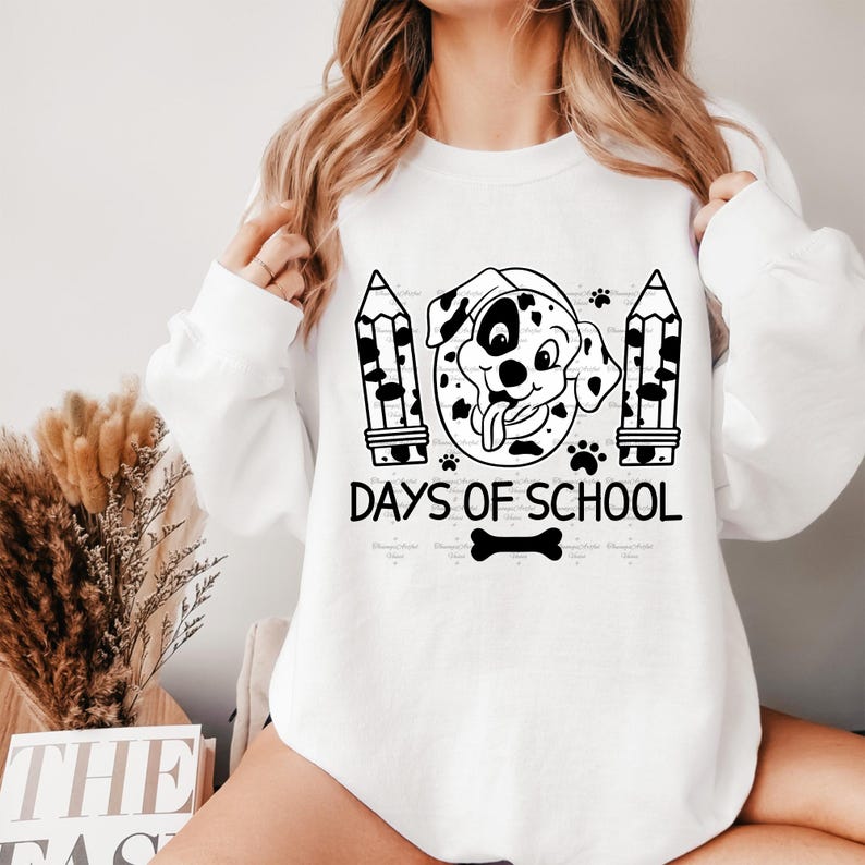 May include: White sweatshirt with a black and white illustration of a dalmatian dog wearing a graduation cap and holding a diploma. The text "Days of School" is printed below the dog.
