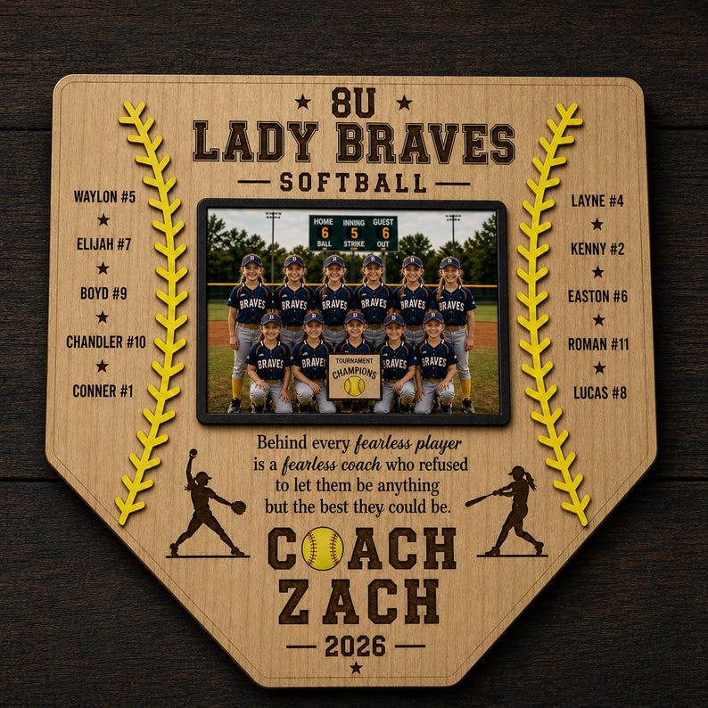 May include: A wooden softball team plaque in the shape of home plate. It features a team photo, player names, and the text "8U Lady Braves Softball." The plaque includes the coach's name and the year 2026.