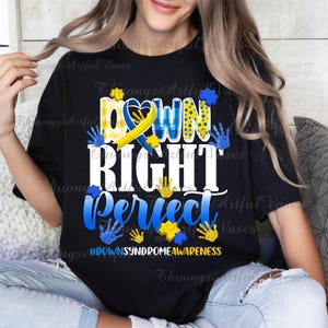 May include: Black t-shirt with a white graphic that says "Down Right Perfect" with a yellow and blue ribbon and handprints. The text "#DownSyndromeAwareness" is at the bottom of the graphic.
