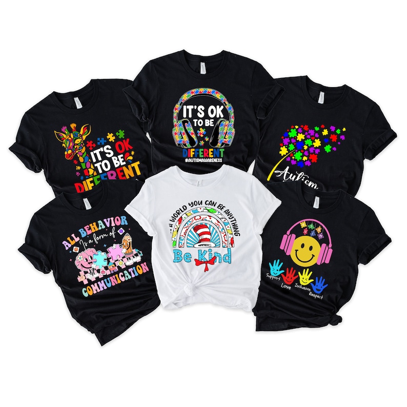 May include: Six different t-shirts with autism awareness designs. The designs include a giraffe, a puzzle piece, a rainbow, a cat in a hat, a dandelion, and a smiley face with headphones. The text on the shirts includes "It's OK to be different", "All behavior is a form of communication", "A world you can be anything", "Be kind", "Autism", and "Support Love Inclusion Respect".