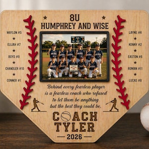 May include: A wooden baseball home plate-shaped plaque with a team photo. The plaque features the text "8U Humphrey and Wise", player names, and "Coach Tyler 2026". Red stitching and baseball silhouettes decorate the edges. A baseball sits to the right.