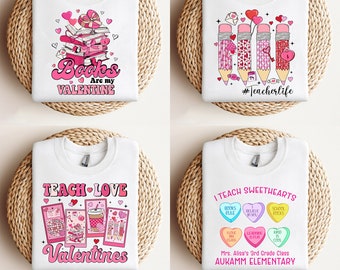 May include: Four white sweatshirts with Valentine's Day designs. One says "Books Are my Valentine" with hearts and a stack of books. Another says "#Teacherlife" with pencils and hearts. The third says "Teach Love Valentines". The last says "I Teach Sweethearts" with candy hearts.