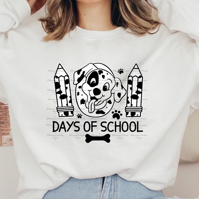 May include: White sweatshirt with a black and white illustration of a Dalmatian dog with a tongue sticking out. The dog is surrounded by two black and white pencils and paw prints. The text "100 Days of School" is below the dog.