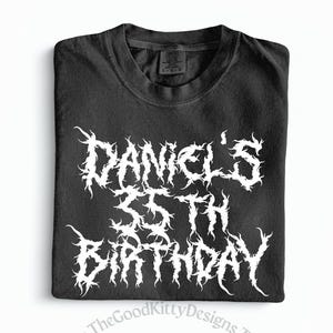 May include: Black t-shirt with the text "Daniel's 35th Birthday" in a white, stylized font. The shirt is folded neatly and appears to be made of a soft material. The GoodKittyDesigns logo is in the bottom left corner.