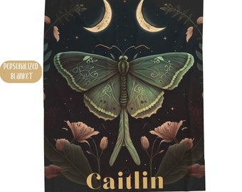 May include: A dark green and black butterfly with intricate patterns on its wings is surrounded by pink flowers and crescent moons on a black background. The name "Caitlin" is written in gold lettering at the bottom of the image.
