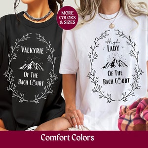 May include: Two white t-shirts with black text and graphics. The text on the shirts reads "High Lady of the Bach Court" and "Valkyrie of the Bach Court".