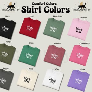 May include: A chart showing 12 different t-shirt colors with the text "Comfort Colors Shirt Colors" at the top. The t-shirts are arranged in four rows of three. Each t-shirt has a different color and the text "white text" or "black text" printed on it. The colors are: Black, Red, Light Green, Blossom, Hemp, Grass, Crimson, Crunchberry, Pepper, Ivory, White, and Violet.