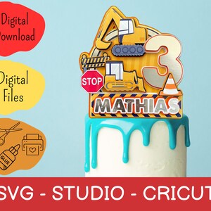 K&ouml;nnte beinhalten: Ein Tortenaufsatz mit Baumaschinen, einem Stoppschild und dem Namen "Mathias" mit der Zahl "3". Der Aufsatz ist gelb, silber und schwarz, auf einem wei&szlig;en und blauen Kuchen. Die W&ouml;rter "Digitaler Download" und "Digitale Dateien" sind ebenfalls sichtbar.