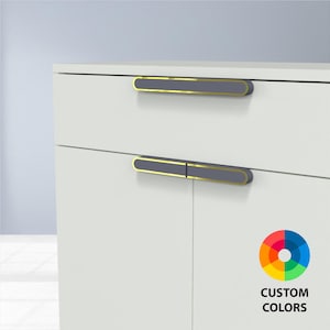 May include: White cabinet with two gray and gold-trimmed handles. The handles are rectangular and horizontal. The image includes a color wheel with the text "CUSTOM COLORS".
