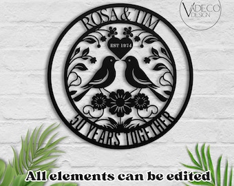 May include: Black metal circle with the names Rosa and Tim, the year 1974, and the text "50 Years Together". The circle is decorated with a floral design and two birds.