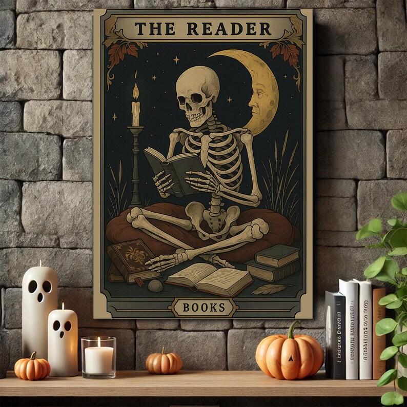 May include: A framed print featuring a skeleton reading a book, with the text "THE READER" at the top and "BOOKS" at the bottom. The background is dark with a crescent moon and stars. The print is displayed on a wooden shelf with candles and pumpkins.