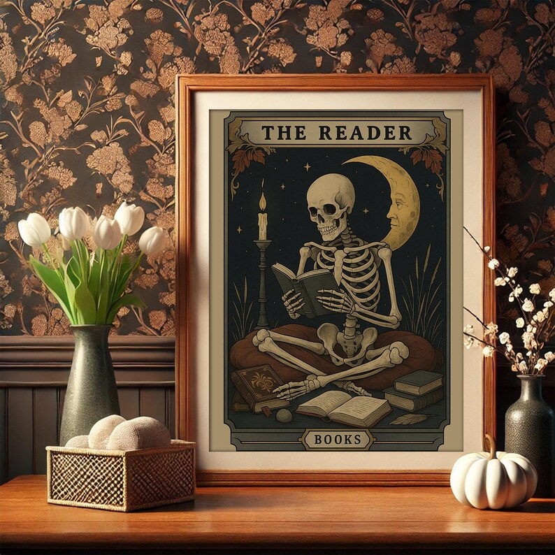 May include: A framed print featuring a skeleton reading a book, with the text "THE READER" at the top. The artwork has a dark, vintage aesthetic, with a crescent moon and stars in the background. The word "BOOKS" is at the bottom.
