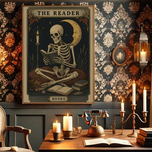 May include: A framed print titled "THE READER" depicts a skeleton reading a book, with a crescent moon and candles. The artwork has a vintage aesthetic, with a dark color palette and the word "BOOKS" at the bottom. The print is displayed in a room with candles and antique decor.
