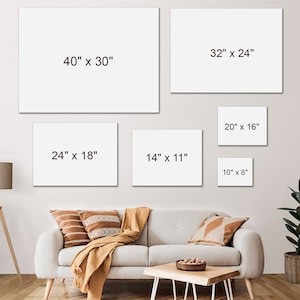 May include: A living room with a white couch and a coffee table. There are five white frames on the wall with different dimensions written on them in inches. The frames are 40" x 30", 32" x 24", 20" x 16", 24" x 18", 14" x 11", and 10" x 8".