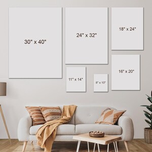 May include: A collection of six blank canvas art prints in various sizes, including 30" x 40", 24" x 32", 18" x 24", 16" x 20", 11" x 14", and 8" x 10". The prints are displayed on a light gray wall above a sofa with decorative pillows and a wooden coffee table.