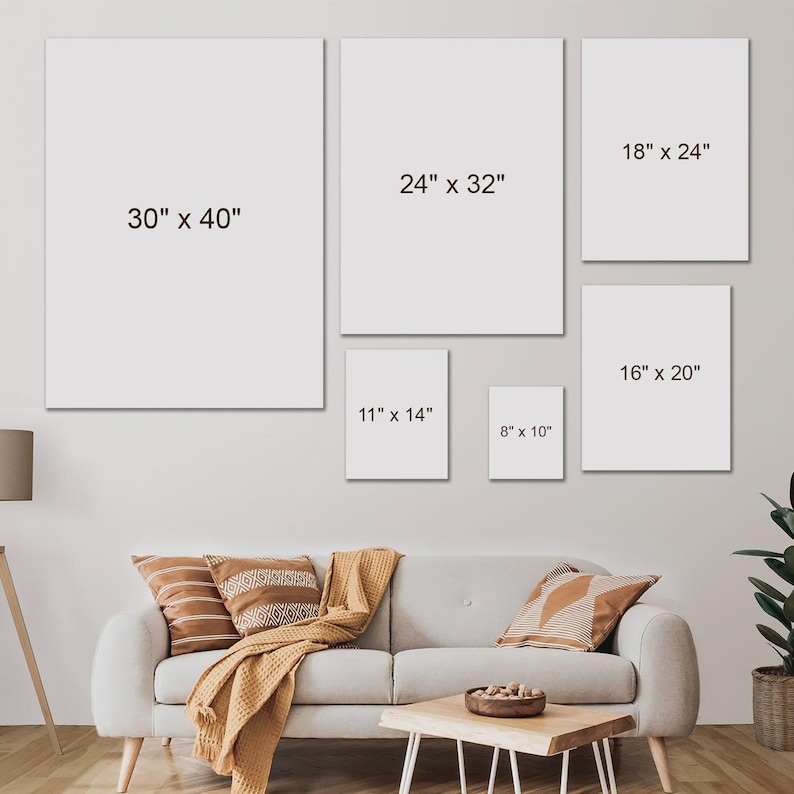 May include: A collection of six blank canvas art prints in various sizes, including 30" x 40", 24" x 32", 18" x 24", 16" x 20", 11" x 14", and 8" x 10". The prints are displayed on a light gray wall above a sofa with decorative pillows and a wooden coffee table.
