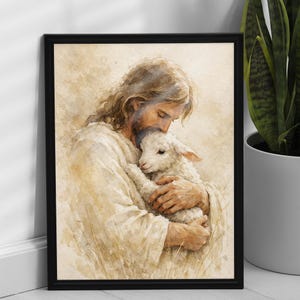 May include: A framed watercolor print depicts a figure in white robes tenderly embracing a lamb. The artwork features soft, warm tones and a serene expression, conveying a sense of comfort and care. The black frame adds a classic touch.