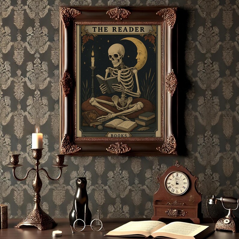 May include: A framed artwork featuring a skeleton reading a book, titled "THE READER" and "BOOKS". The artwork is set against a dark background with a crescent moon and stars. The frame is ornate, and the overall aesthetic is vintage.