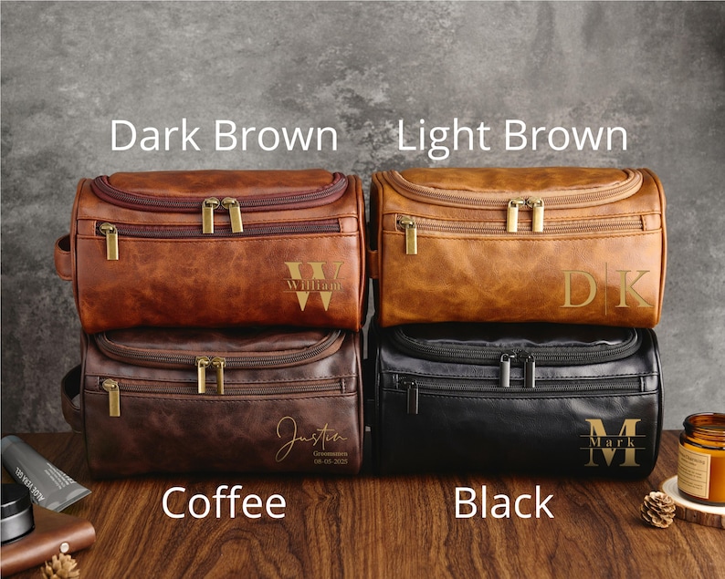May include: Four toiletry bags in different colors: dark brown, light brown, coffee, and black. Each bag has a zipper closure and a personalized monogram.