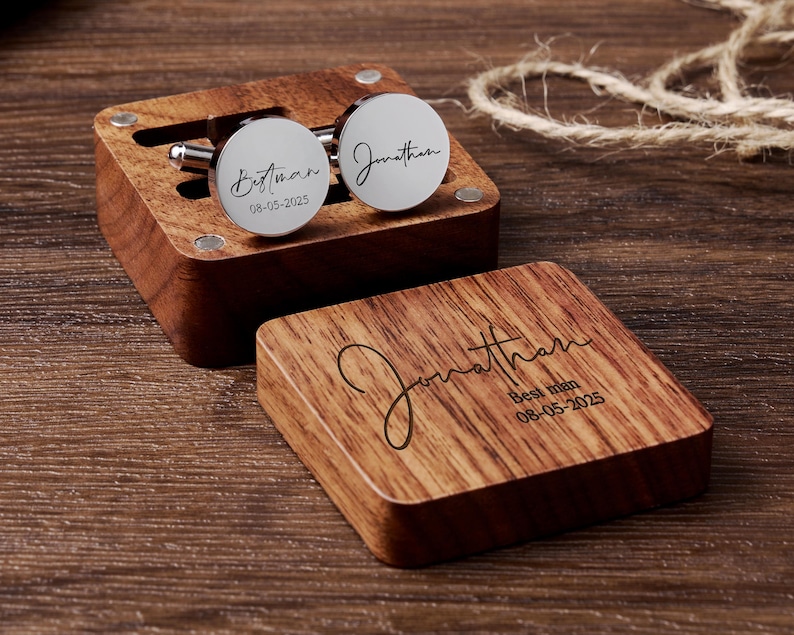 May include: A wooden box with a hinged lid, engraved with the name "Jonathan" and the words "Best Man" with the date "08-05-2025". The box contains two silver cufflinks, one engraved with "Best Man" and the date "08-05-2025", and the other engraved with "Jonathan".