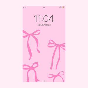May include: A pink iPhone screen with a digital clock displaying 11:04 and the text "41% Charged". The background is pink with four pink bows.
