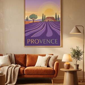 May include: A framed wall art print featuring a stylized landscape of a lavender field in Provence. The illustration depicts rows of purple lavender, a stone house, cypress trees, and a setting sun in a gradient sky. The word PROVENCE is printed.