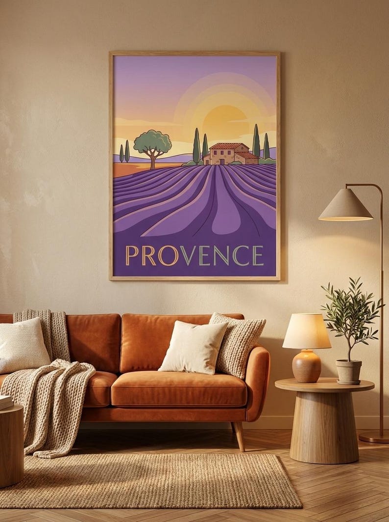 May include: A framed wall art print featuring a stylized landscape of a lavender field in Provence. The illustration depicts rows of purple lavender, a stone house, cypress trees, and a setting sun in a gradient sky. The word PROVENCE is printed.