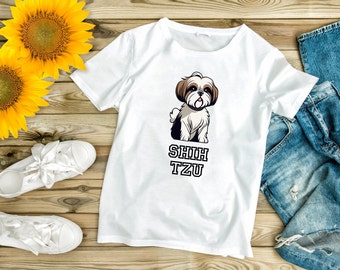 May include: White t-shirt with a cartoon Shih Tzu dog and the text "Shih Tzu" printed on it. The shirt is laid out on a wooden surface with sunflowers, white sneakers, and blue jeans.