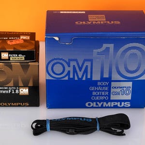 Olympus OM10 film camera with 50mm lens in original boxes