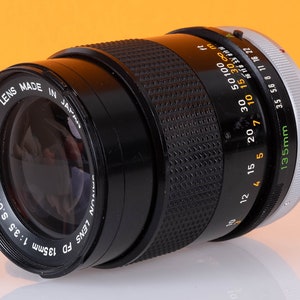 Canon FD SC 135mm f3.5 lens with front and rear caps