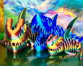 May include: Three iridescent 3D printed dinosaur skeletons in blue, green, and orange. The skeletons are posed in a playful manner, with their jaws open and their tails curled.