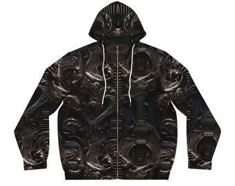 Può includere: Una felpa con cappuccio nera con zip con un motivo dorato e nero di disegni intricati. La felpa ha un cappuccio con coulisse.
