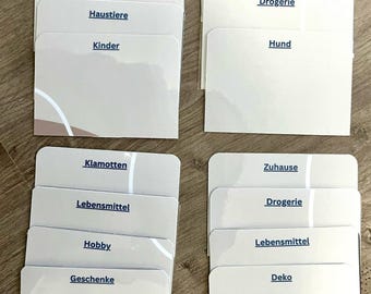 May include: A set of eight white index cards with blue text labels. The labels are for different categories, such as "Beauty", "Pets", "Children", "Hobby", "Gifts", "Pharmacy", "Dog", "Clothes", "Food", "Home", "Decor".