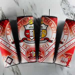 May include: Four red and white insulated tumblers with a Kappa Alpha Psi fraternity logo and the text "Kappa Alpha Psi Established 1911".