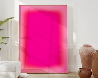 Puede incluir: Una impresión de arte abstracto enmarcada con un fondo degradado rosa. La impresión está en un marco dorado y está colgada en una pared blanca.