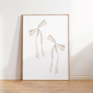 May include: A framed print featuring two white watercolour bows against a white background.