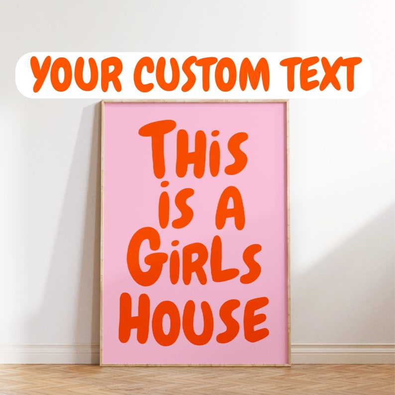 May include: A pink framed poster with the text "This is a girls house" in orange lettering.