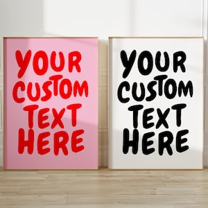 May include: Two framed prints with the text "Your Custom Text Here" in red and black on a pink and white background.