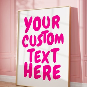 May include: A white framed poster with the text "YOUR CUSTOM TEXT HERE" in large, pink, bubble letters.