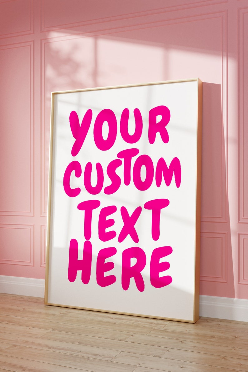 May include: A white framed poster with the text "YOUR CUSTOM TEXT HERE" in large, pink, bubble letters.