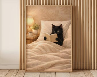 Puede incluir: Impresión enmarcada que representa a un gato negro leyendo un libro en la cama. El gato está bajo una manta y almohada beige. Se ve una mesita de noche con una lámpara, una planta y una taza de café. El fondo presenta una pared de madera.