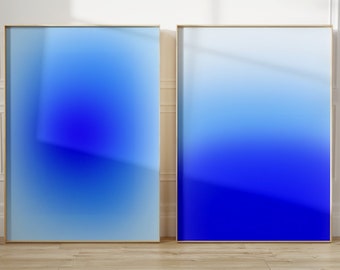 May include: Two framed abstract art prints with a gradient of blue shades, from light blue to dark blue.