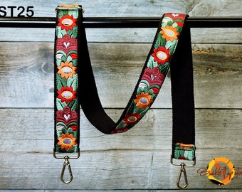 May include: Black adjustable strap with a floral pattern in red, orange, green, and pink. The strap has two silver swivel clips. The text "ST25" is visible in the top left corner of the image.