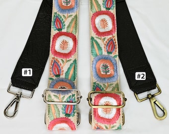 May include: Two embroidered bag straps with floral patterns in red, blue, and green on a beige background. The straps have black leather ends with metal clasps and the text "ST-627", "#1", and "#2".