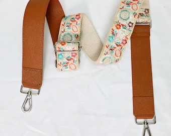 May include: A brown leather and floral patterned fabric adjustable strap with silver hardware and the text "ST-638".