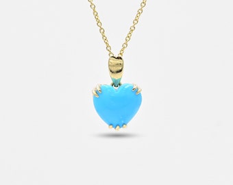 May include: A gold chain necklace with a blue heart pendant. The heart is made of turquoise and has a gold border.